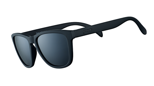 Three-quarter angle view of square-framed black sunglasses with black lenses on a white background.