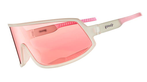 Three-quarter angle view of wraparound sunglasses with clear frames and a rose-tinted non-reflective single lens.
